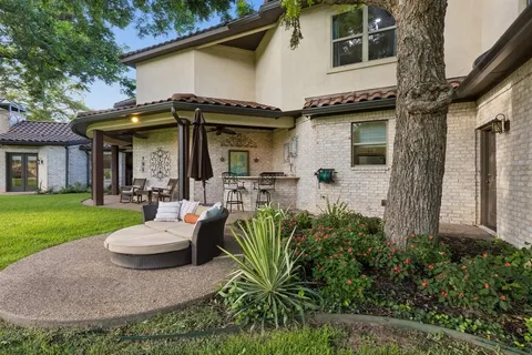 an aerial view of a house with a yard and garden