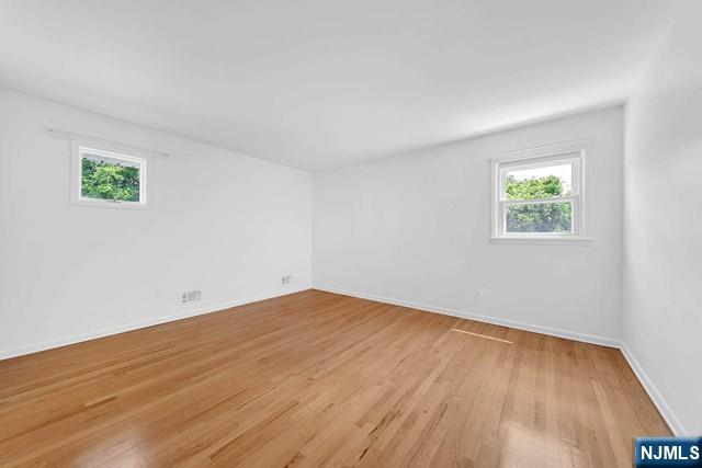 516 Knickerbocker Road Cresskill, NJ 07626 - Photo 16 of 31 an empty room with wooden floor and windows