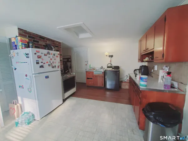 a kitchen with stainless steel appliances a refrigerator and a stove top oven