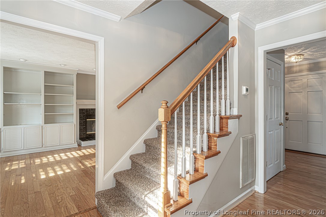 7787 Trappers Road Fayetteville, NC 28311 - Photo 11 of 47 a view of staircase with wooden floor and a rug