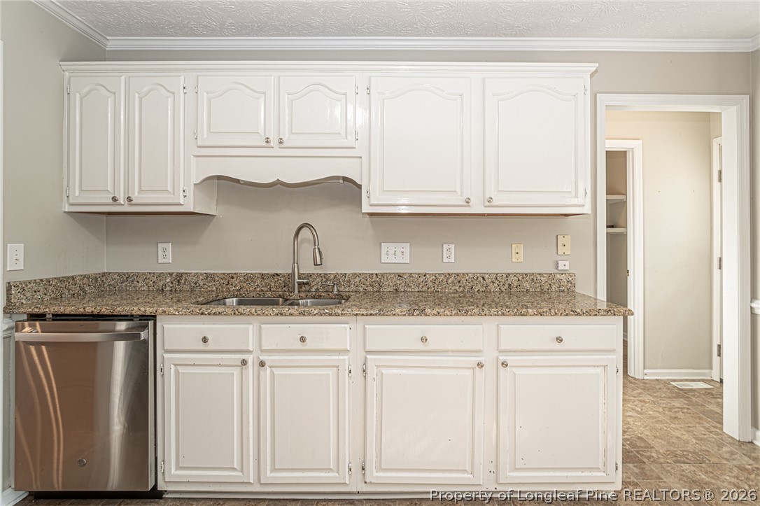 7787 Trappers Road Fayetteville, NC 28311 - Photo 14 of 47 a kitchen with granite countertop white cabinets and a granite counter top