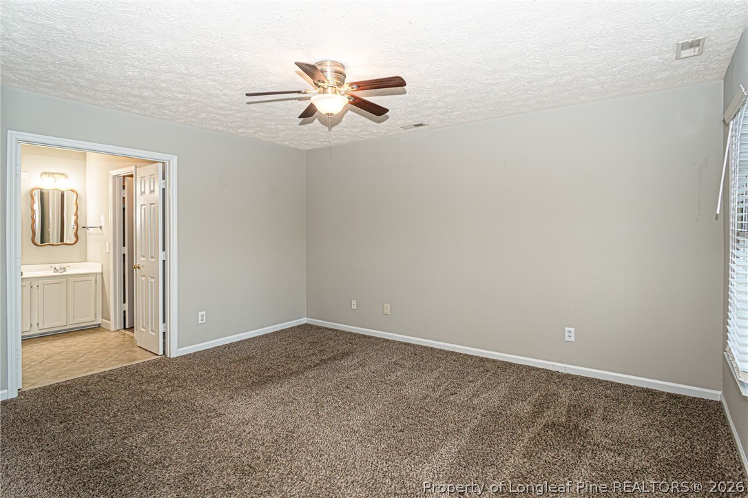 7787 Trappers Road Fayetteville, NC 28311 - Photo 21 of 47 an empty room with windows and fan