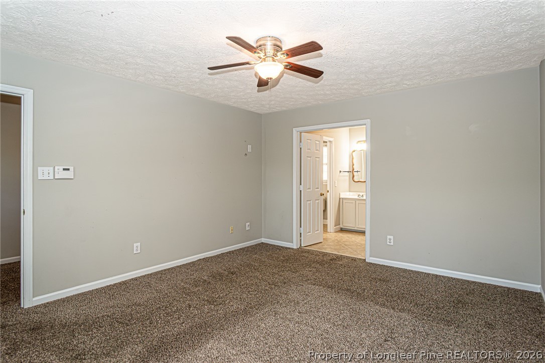 7787 Trappers Road Fayetteville, NC 28311 - Photo 22 of 47 an empty room with closet and ceiling fan