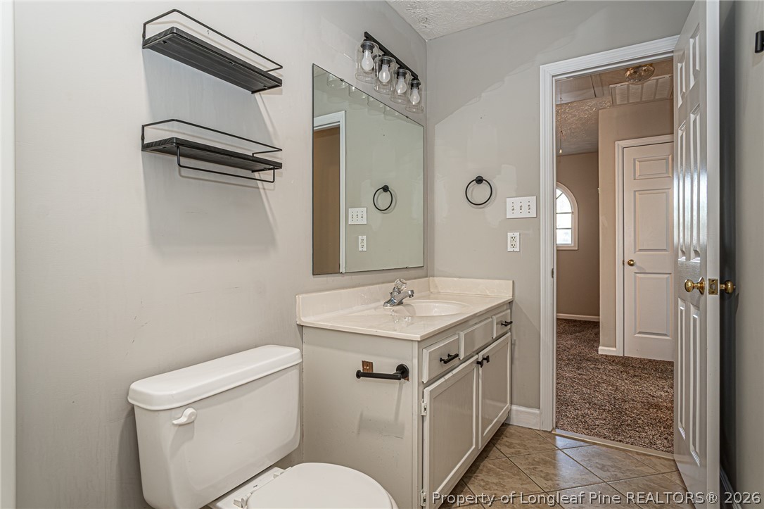 7787 Trappers Road Fayetteville, NC 28311 - Photo 28 of 47 a bathroom with a sink a toilet and shower