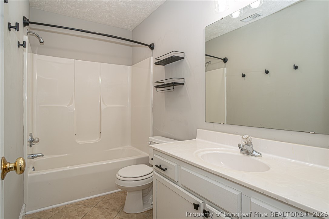 7787 Trappers Road Fayetteville, NC 28311 - Photo 29 of 47 a bathroom with a granite countertop sink toilet and shower