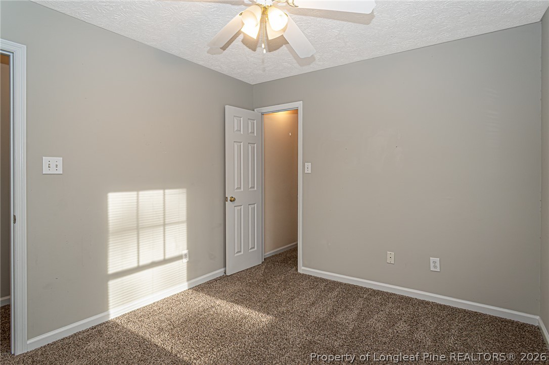 7787 Trappers Road Fayetteville, NC 28311 - Photo 32 of 47 an empty room with windows and cabinet