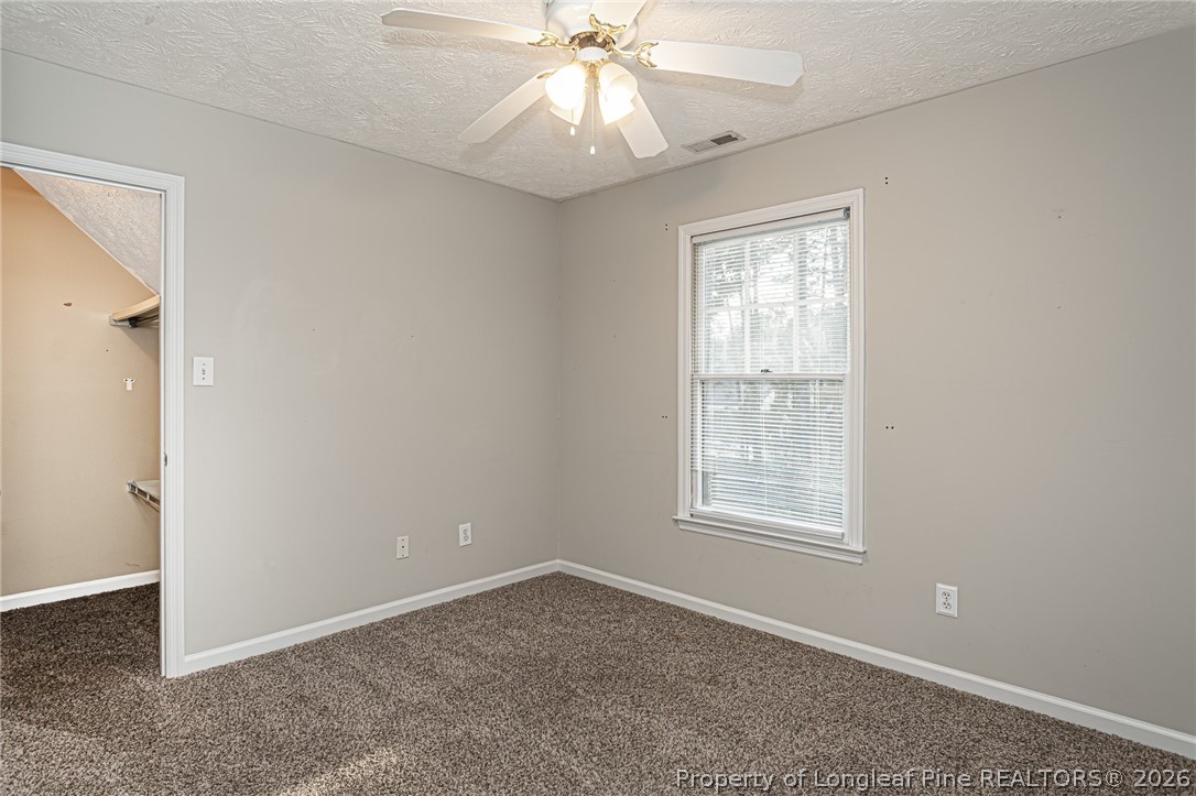 7787 Trappers Road Fayetteville, NC 28311 - Photo 34 of 47 an empty room with a window and a fan