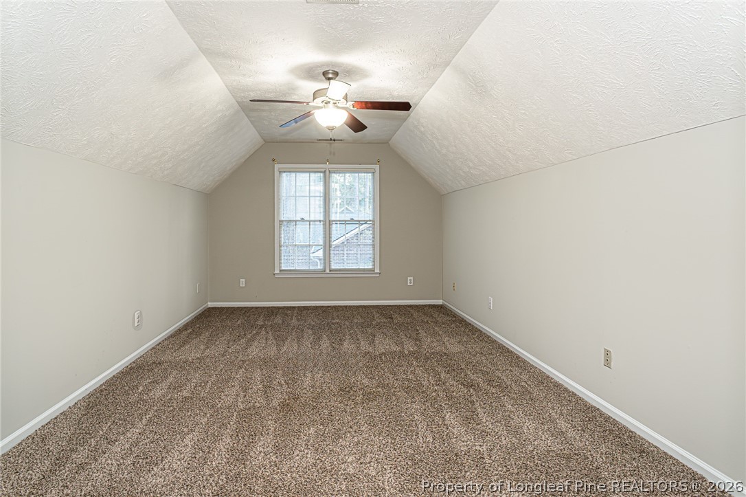 7787 Trappers Road Fayetteville, NC 28311 - Photo 35 of 47 an empty room with a chandelier fan and windows