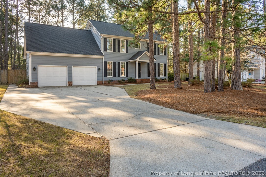 7787 Trappers Road Fayetteville, NC 28311 - Photo 38 of 47 a front view of a house with a yard and garage