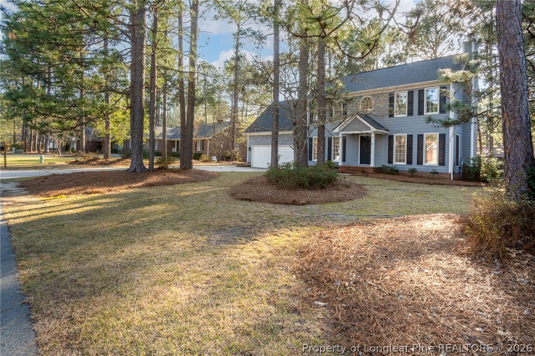 7787 Trappers Road Fayetteville, NC 28311 - Photo 39 of 47 a view of a big house with a big yard and large trees
