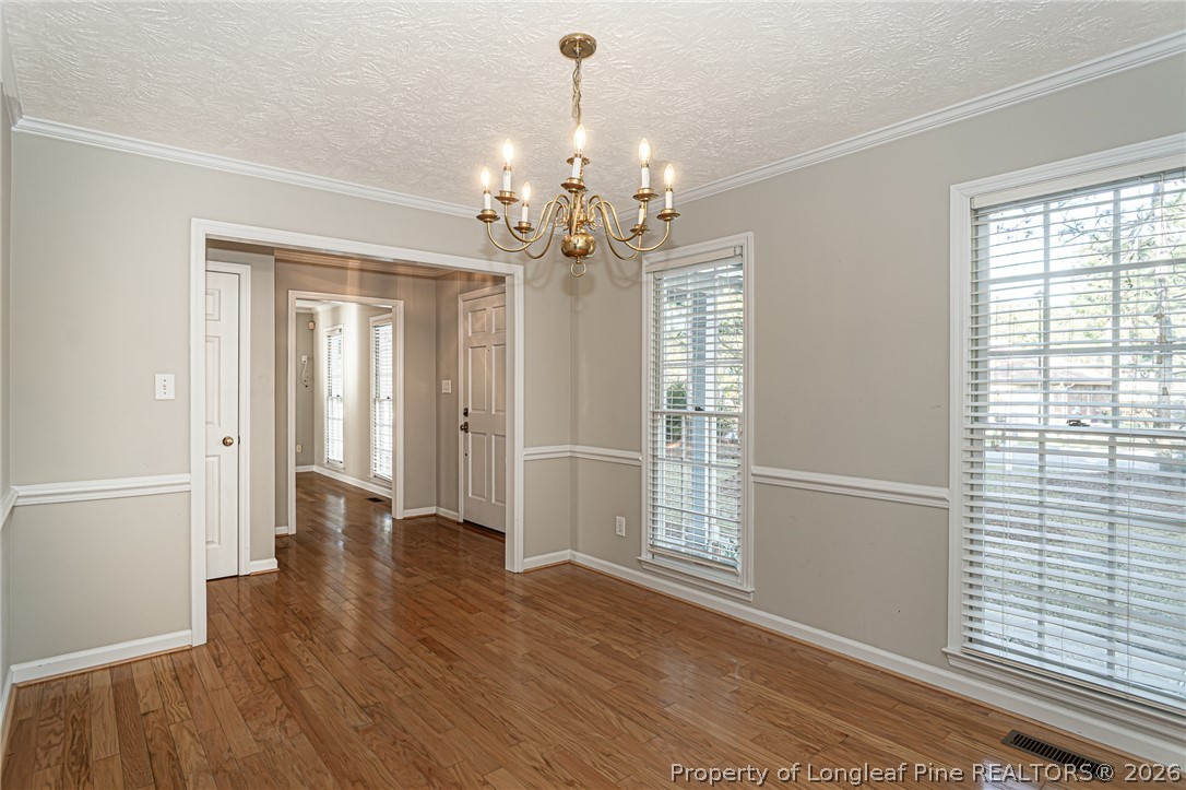 7787 Trappers Road Fayetteville, NC 28311 - Photo 5 of 47 a view of an empty room with wooden floor and a window