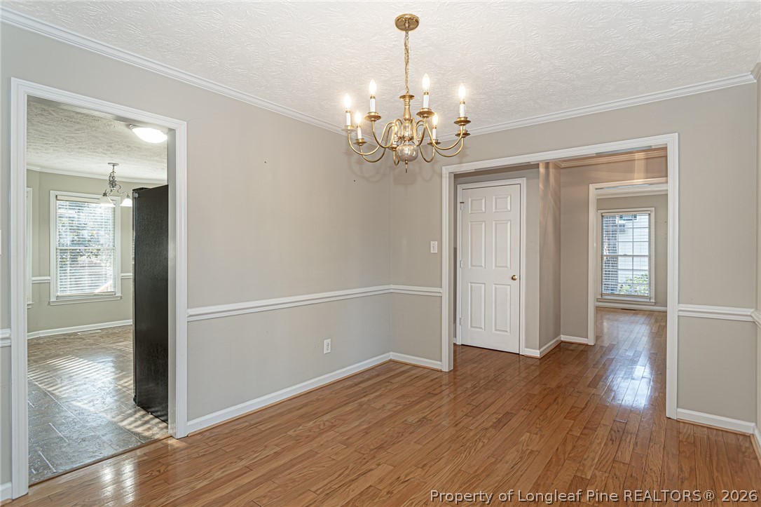 7787 Trappers Road Fayetteville, NC 28311 - Photo 6 of 47 a view of an empty room with wooden floor