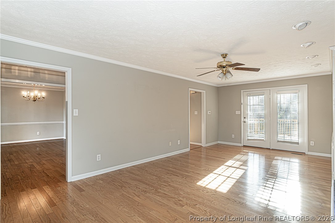 7787 Trappers Road Fayetteville, NC 28311 - Photo 8 of 47 a view of empty room with wooden floor and fan