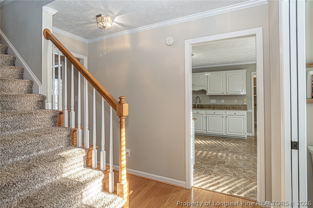 7787 Trappers Road Fayetteville, NC 28311 - Photo 10 of 47 a view of a hallway with wooden floor and cabinet