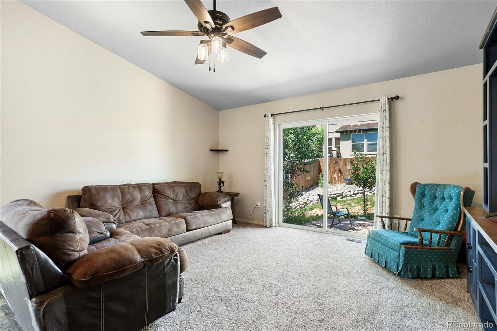 2556 Hannah Ridge Drive Colorado Springs, CO 80922 - Photo 11 of 39 a living room with furniture and a chandelier