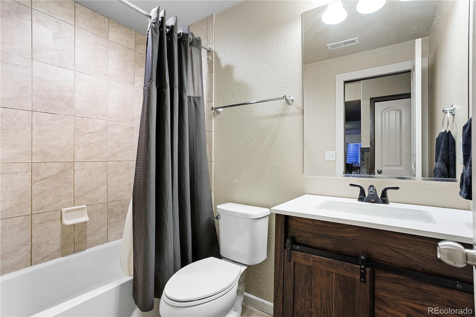 2556 Hannah Ridge Drive Colorado Springs, CO 80922 - Photo 21 of 39 a bathroom with a sink a toilet a mirror and shower