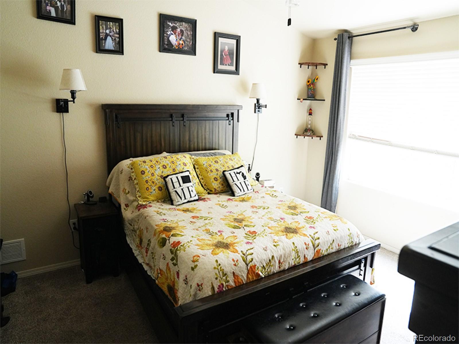 2556 Hannah Ridge Drive Colorado Springs, CO 80922 - Photo 30 of 39 a bed sitting in a bedroom next to a bathroom