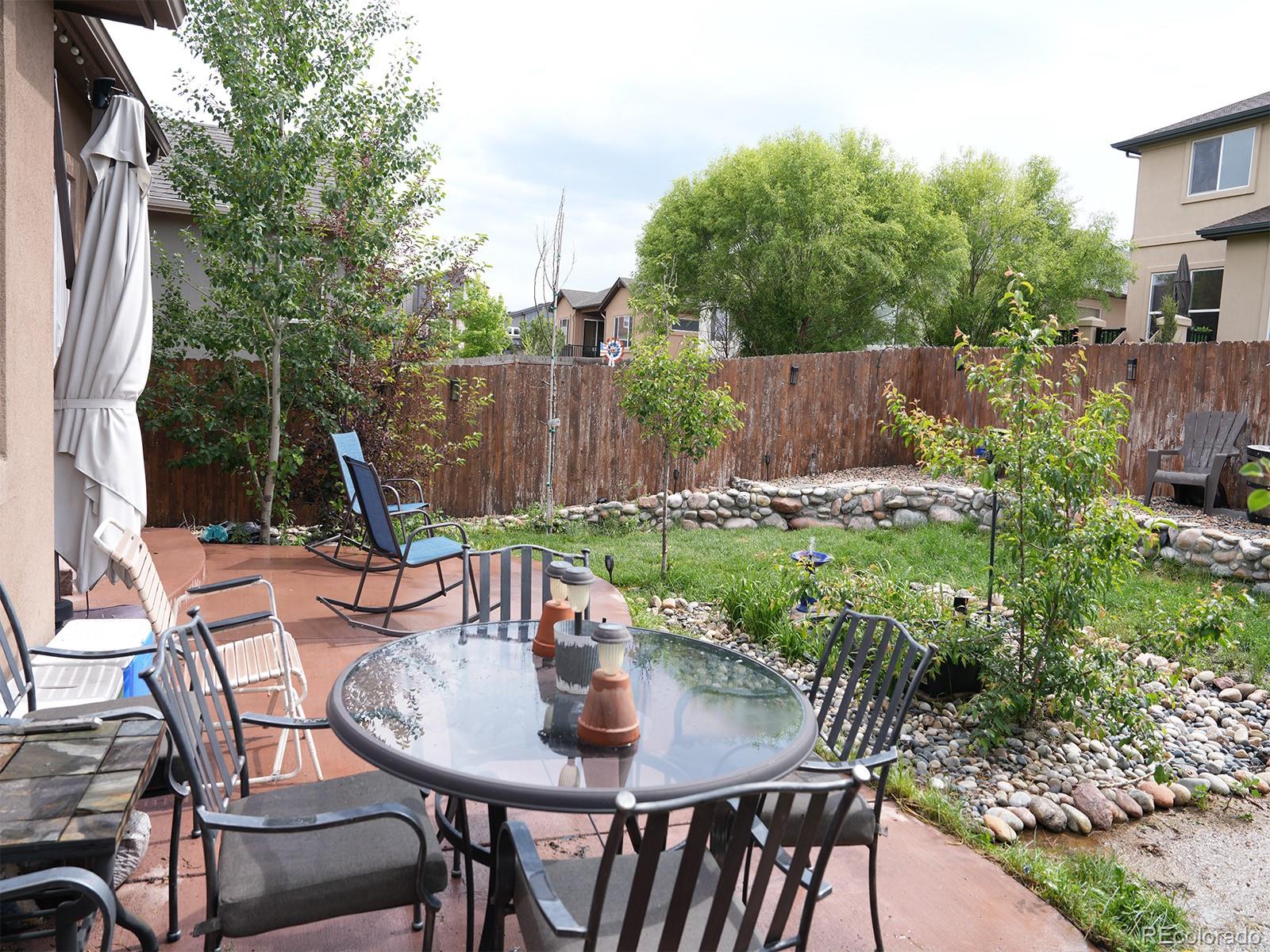 2556 Hannah Ridge Drive Colorado Springs, CO 80922 - Photo 35 of 39 a view of outdoor dining space with a table and chairs