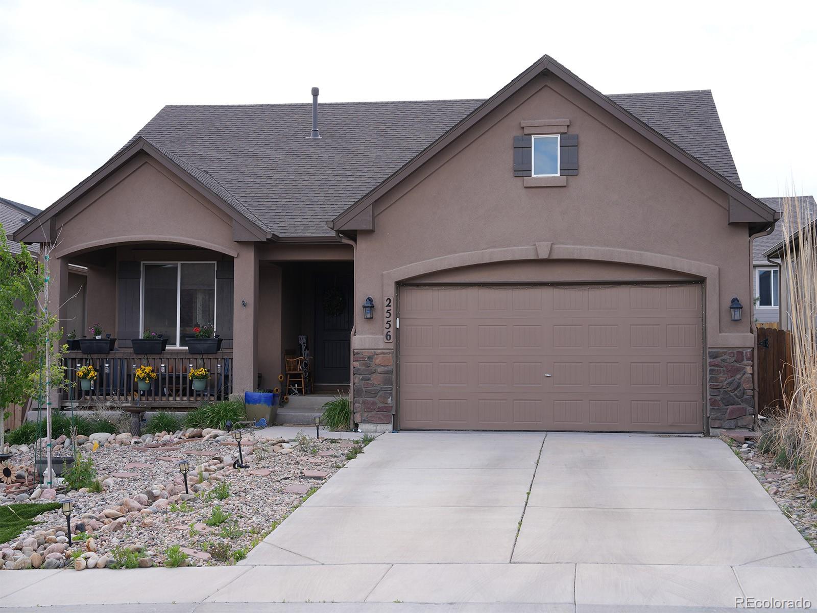 2556 Hannah Ridge Drive Colorado Springs, CO 80922 - Photo 36 of 39 a front view of a house with garden