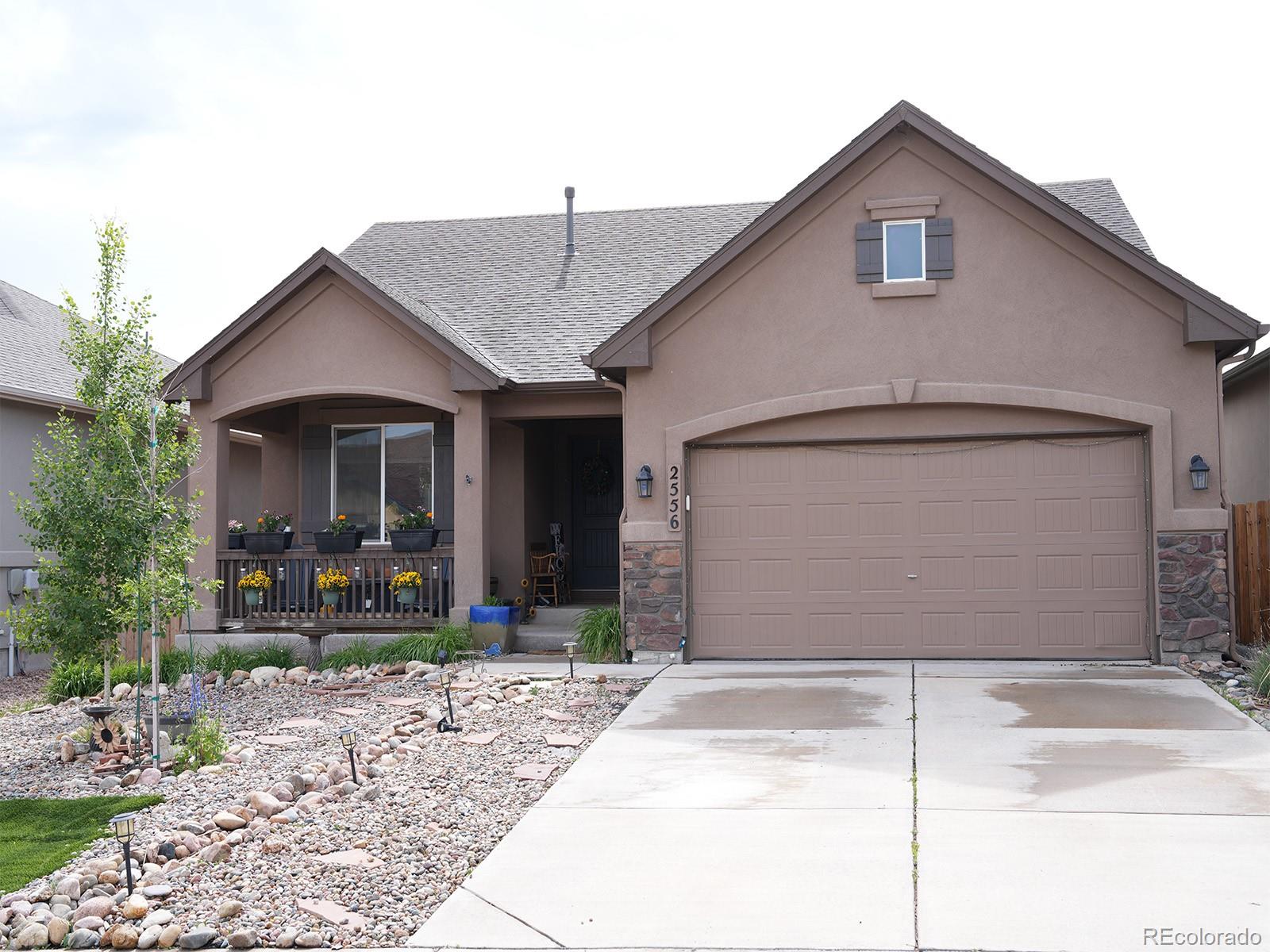 2556 Hannah Ridge Drive Colorado Springs, CO 80922 - Photo 37 of 39 a front view of a house with garden