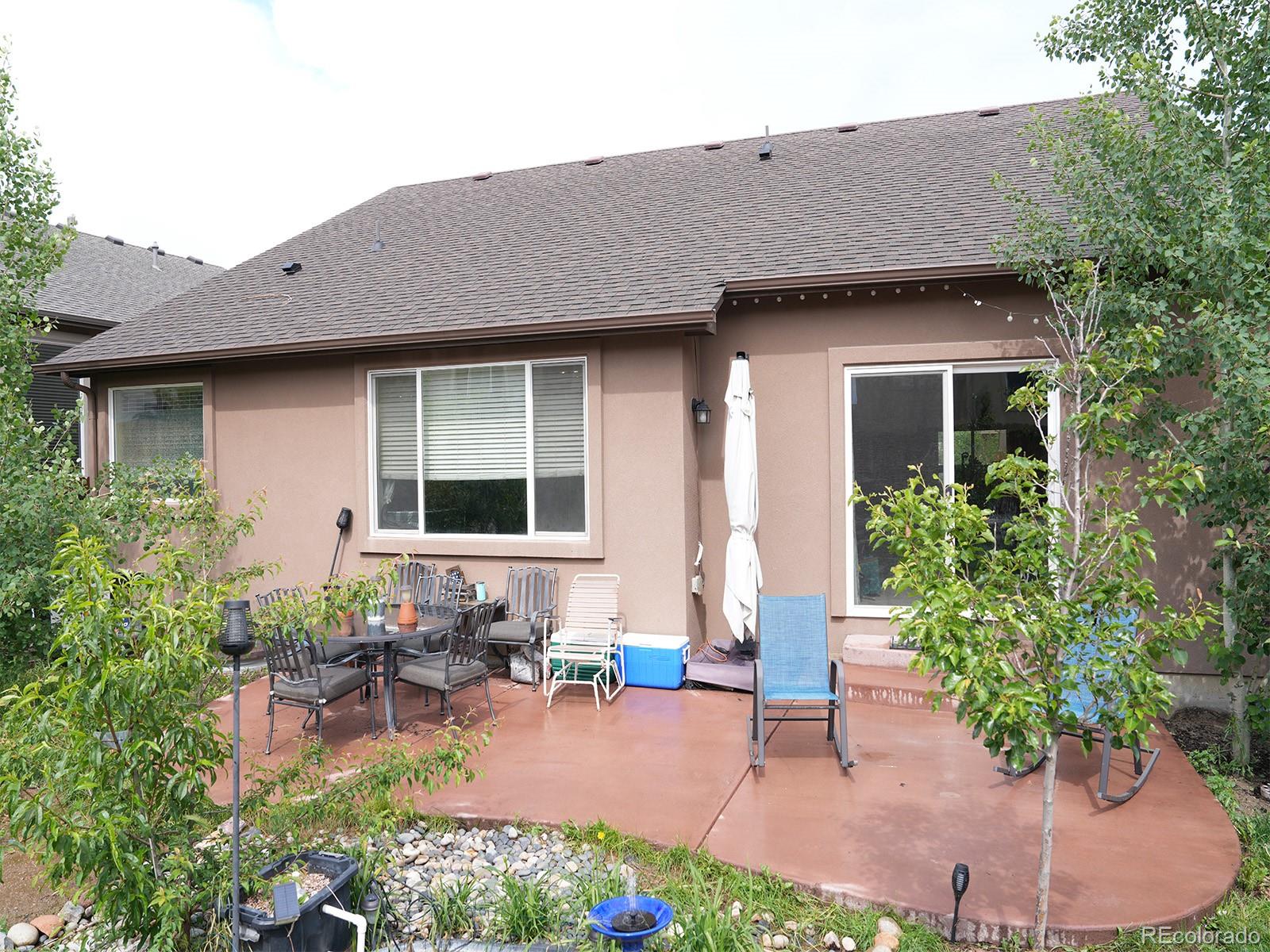 2556 Hannah Ridge Drive Colorado Springs, CO 80922 - Photo 38 of 39 a view of a patio with table and chairs and potted plants