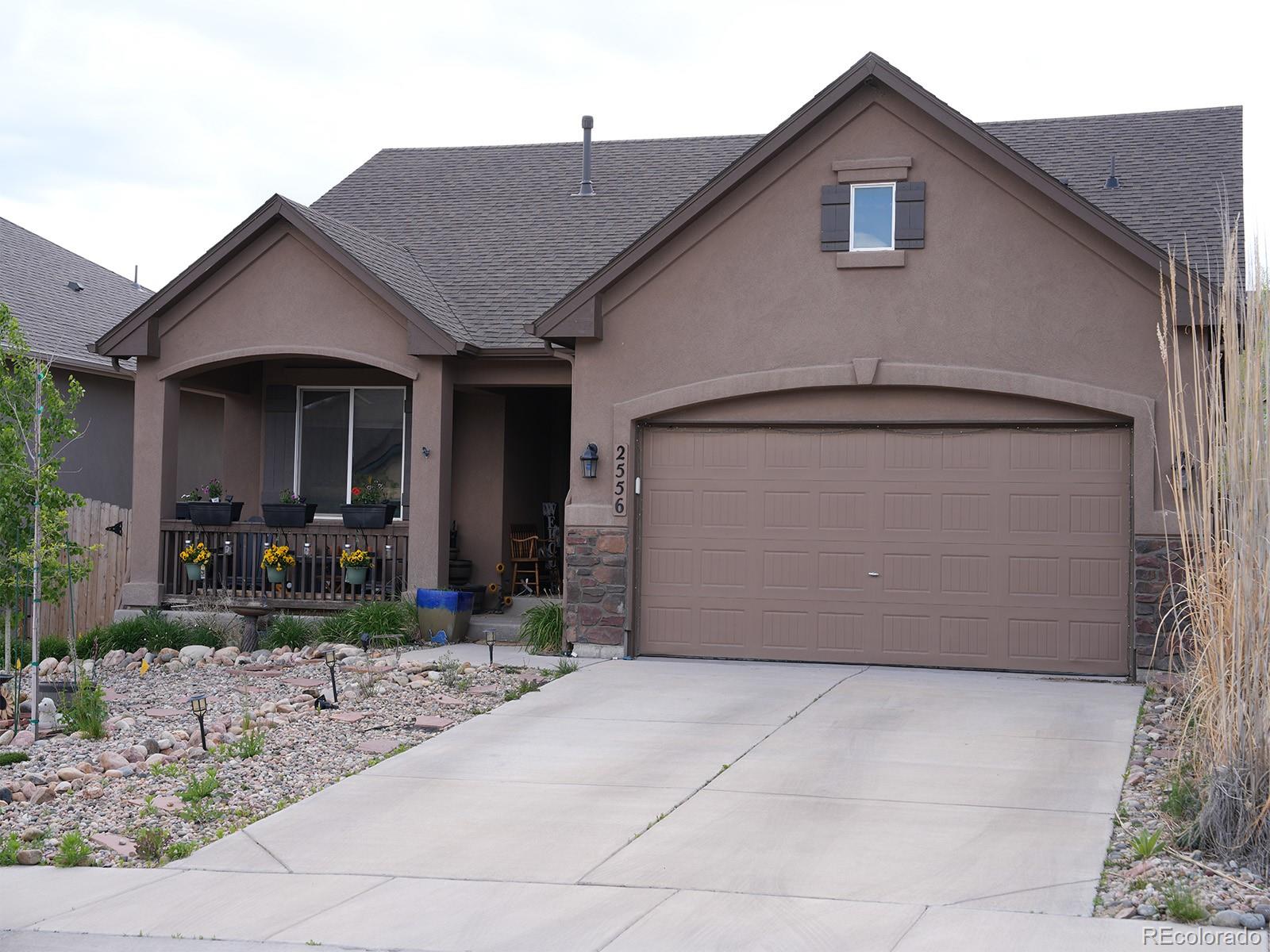 2556 Hannah Ridge Drive Colorado Springs, CO 80922 - Photo 39 of 39 a front view of a house with garden