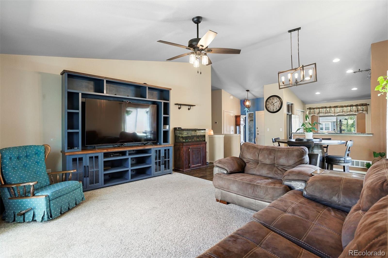 2556 Hannah Ridge Drive Colorado Springs, CO 80922 - Photo 8 of 39 a living room with furniture and a flat screen tv