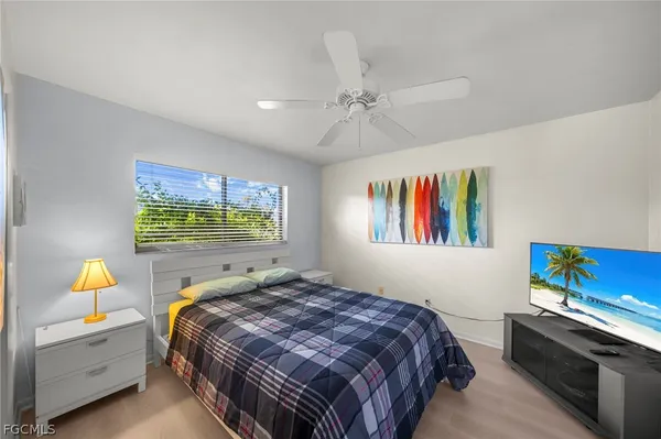 a bedroom with a bed and a window