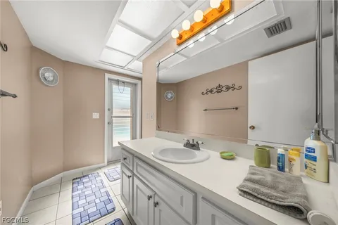 a bedroom with a bed and a ceiling fan