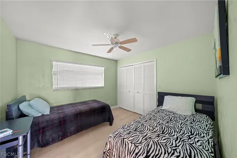a view of swimming pool with outdoor seating and house in the background