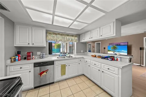 a kitchen with kitchen island a sink stove and white cabinets