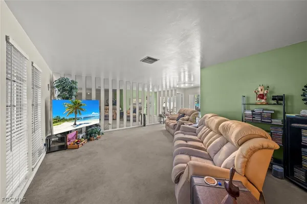 a reading room with furniture and a flat screen tv