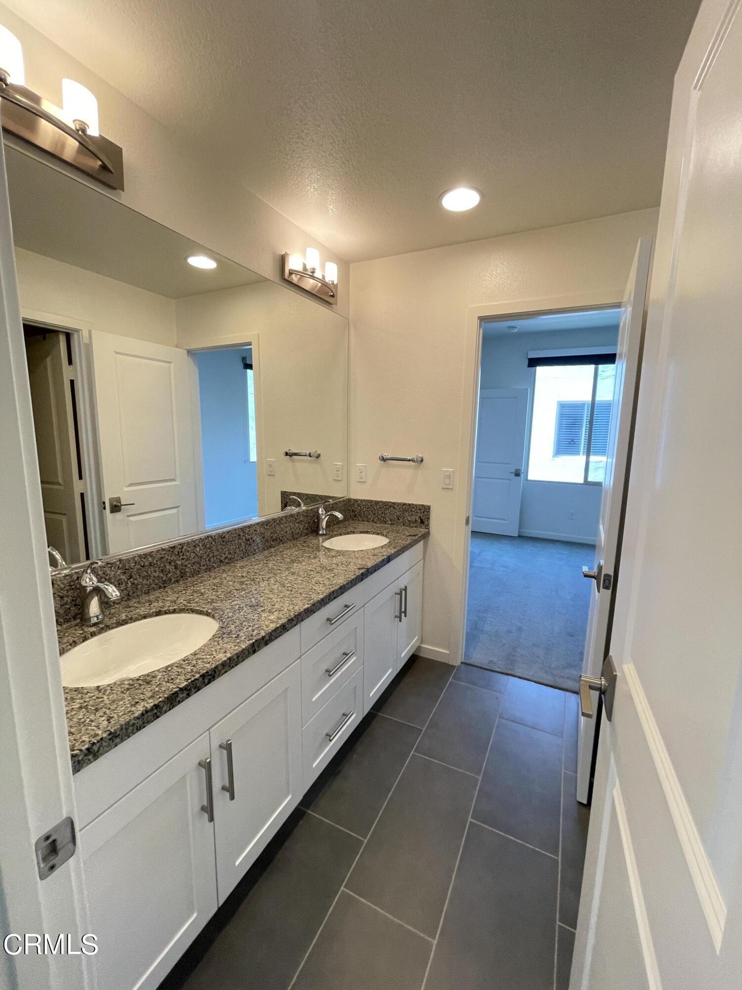 5524 Palm Drive Hawthorne, CA 90250 - Photo 11 of 46 a bathroom with a granite countertop double vanity sink and a mirror