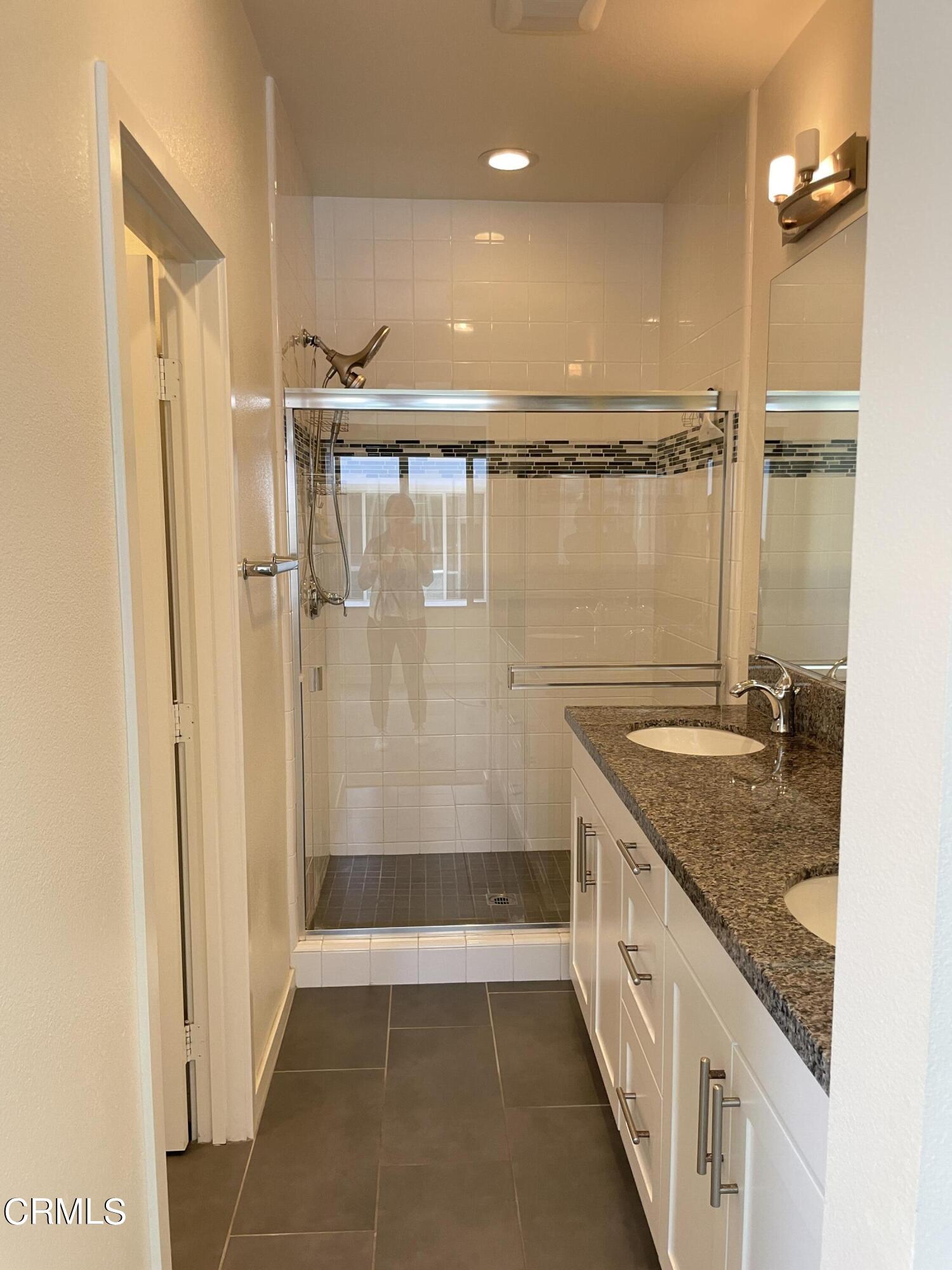 5524 Palm Drive Hawthorne, CA 90250 - Photo 13 of 46 a bathroom with a granite countertop sink a mirror and shower