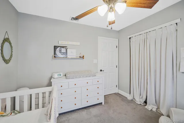 a bedroom with a baby bed baby crib and a window