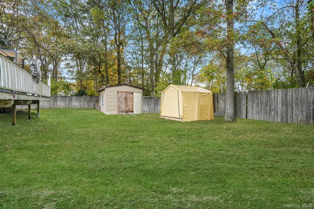 a view of a house with backyard sitting area and garden