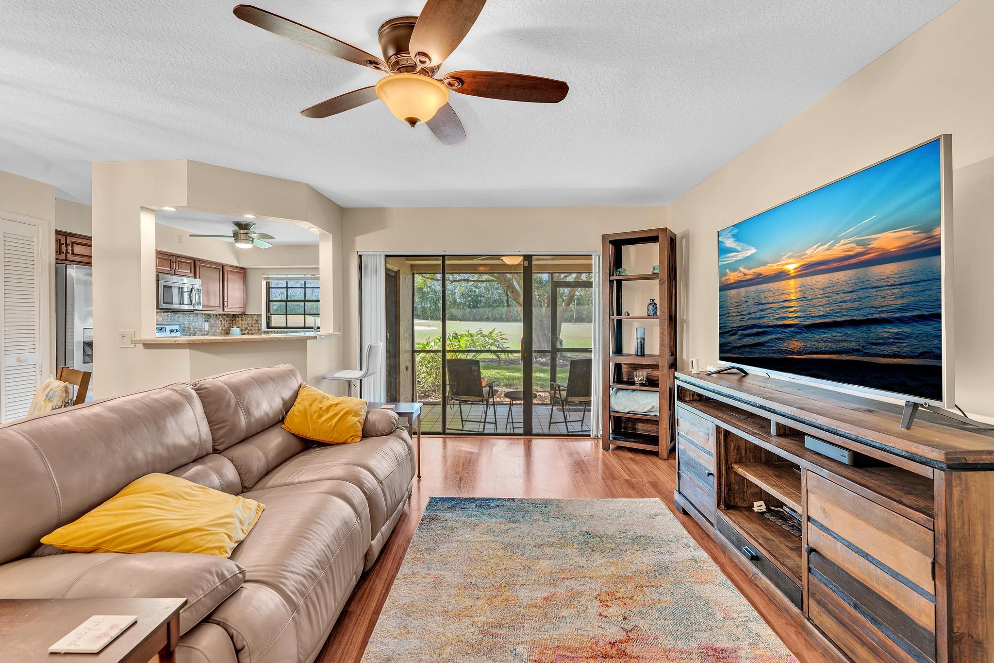 17372 Boca Club Boulevard, Unit 405 Boca Raton, FL 33487 - Photo 14 of 74 a living room with furniture and a flat screen tv