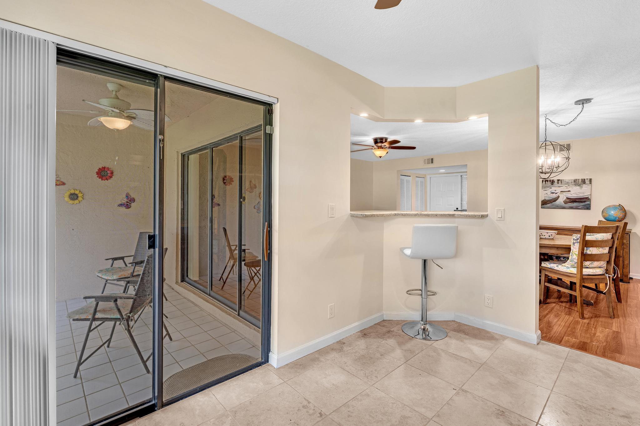 17372 Boca Club Boulevard, Unit 405 Boca Raton, FL 33487 - Photo 32 of 74 wooden floor and table and chairs in a room