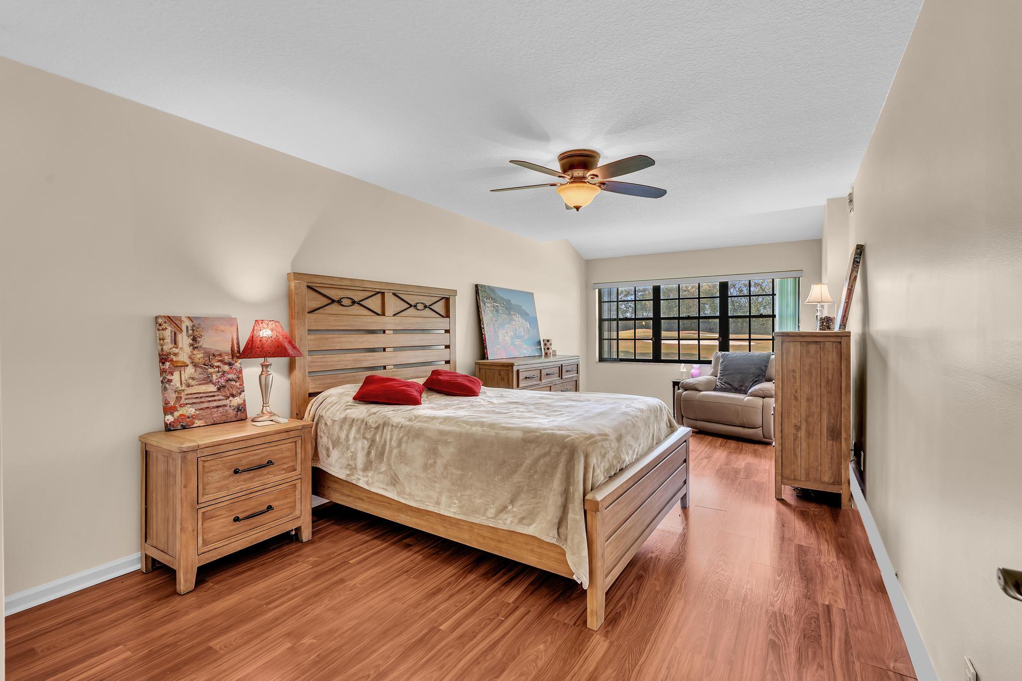 17372 Boca Club Boulevard, Unit 405 Boca Raton, FL 33487 - Photo 38 of 74 a bedroom with a bed and wooden floor