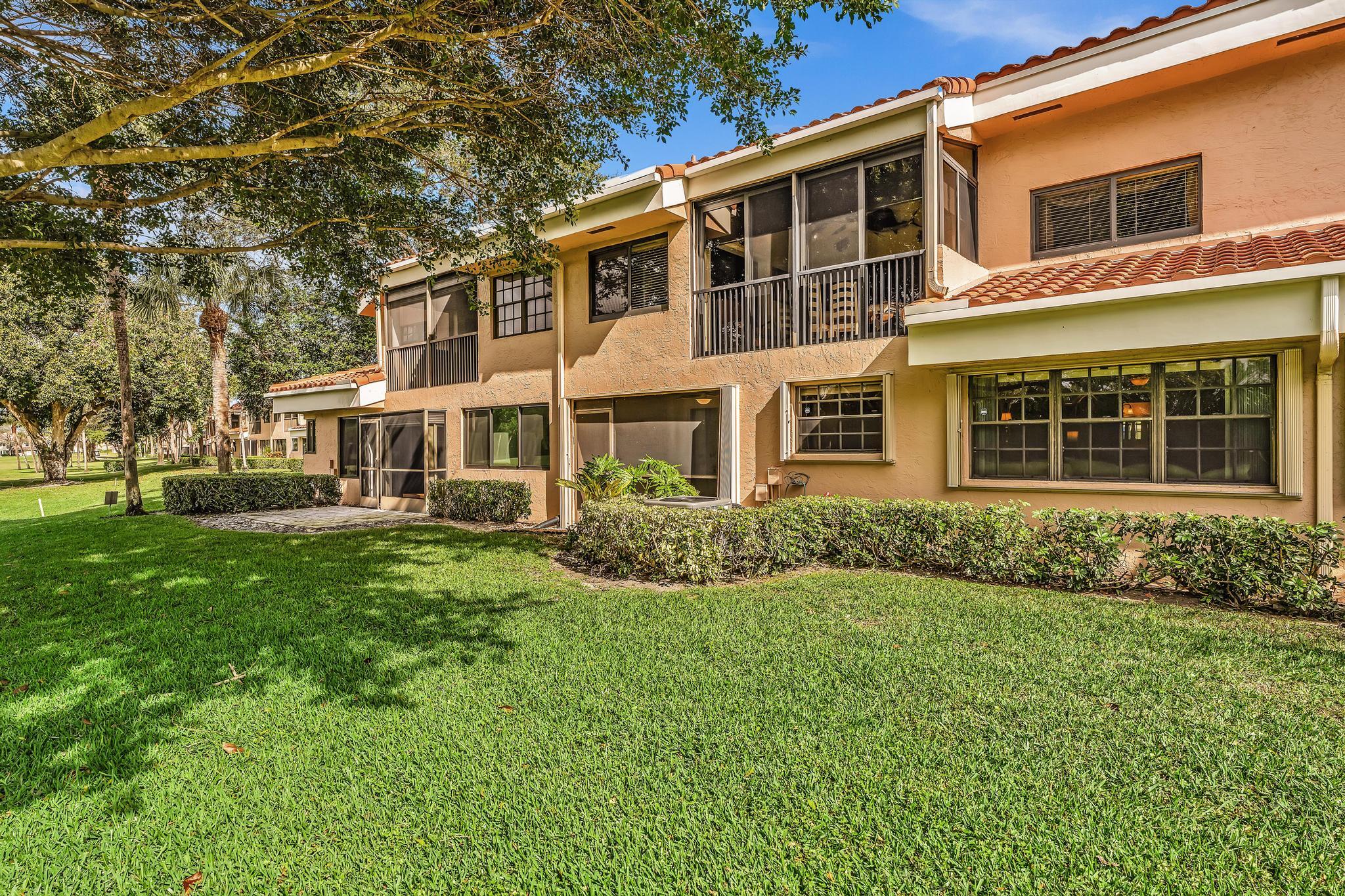 17372 Boca Club Boulevard, Unit 405 Boca Raton, FL 33487 - Photo 52 of 74 a front view of a house with a yard