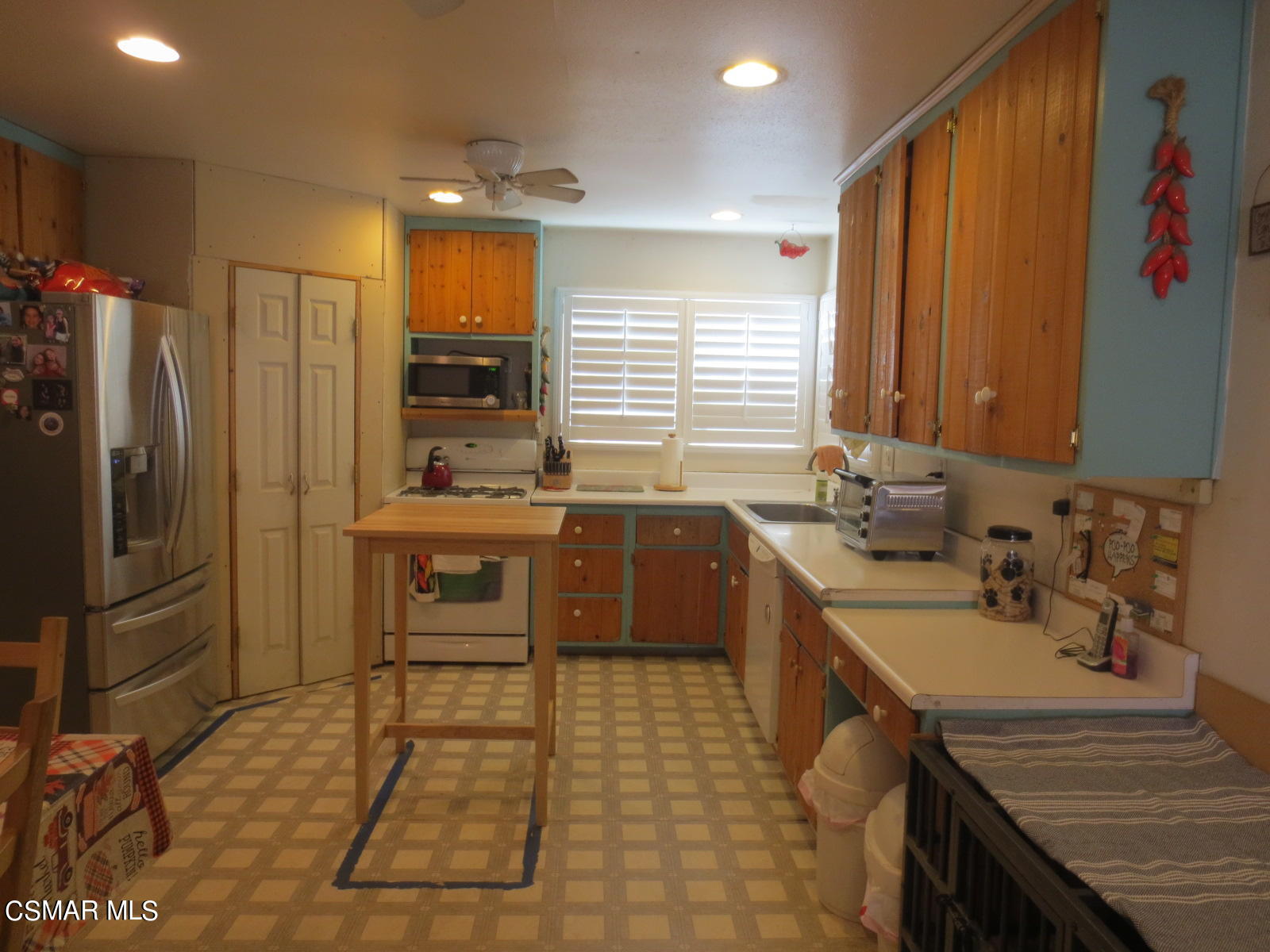 4521 Alpine Street Simi Valley, CA 93063 - Photo 16 of 62 a kitchen with a sink stove and refrigerator