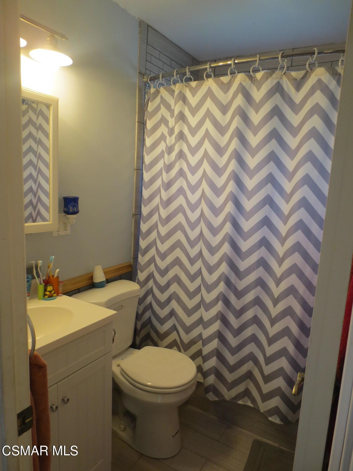 4521 Alpine Street Simi Valley, CA 93063 - Photo 27 of 62 a bathroom with a sink a toilet and a mirror