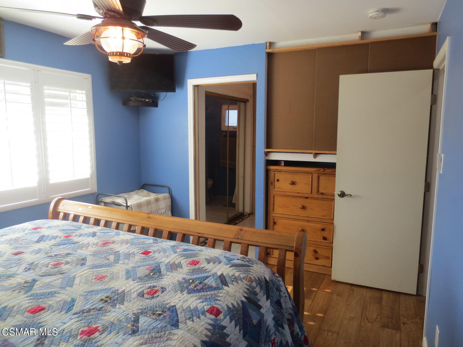 4521 Alpine Street Simi Valley, CA 93063 - Photo 32 of 62 a bedroom with a bed and a chandelier