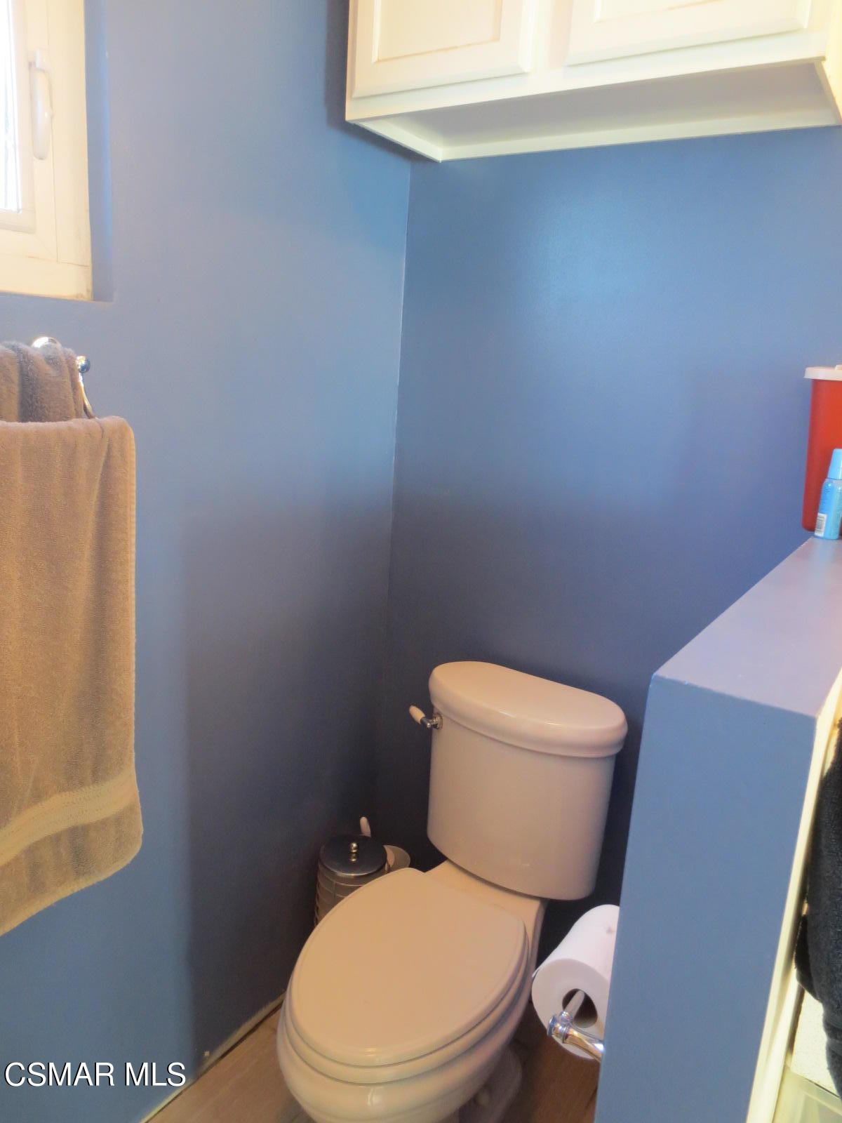 4521 Alpine Street Simi Valley, CA 93063 - Photo 37 of 62 a white toilet sitting next to a white sink and vanity