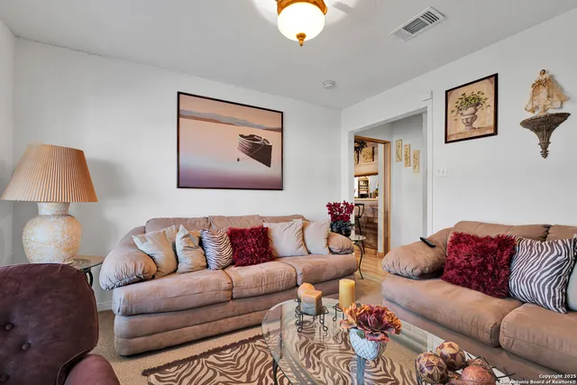 a living room with furniture and a lamp