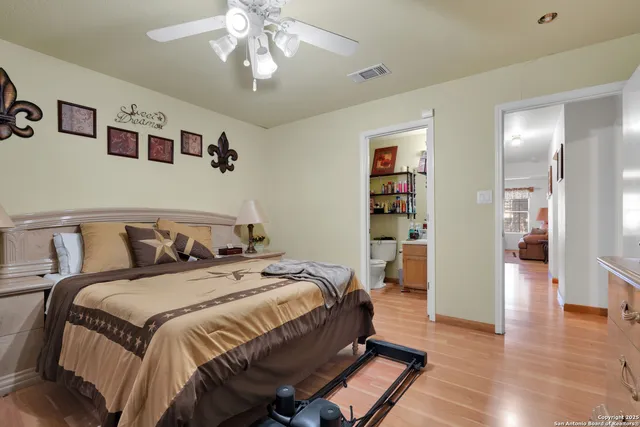 a bedroom with bed and wooden floor