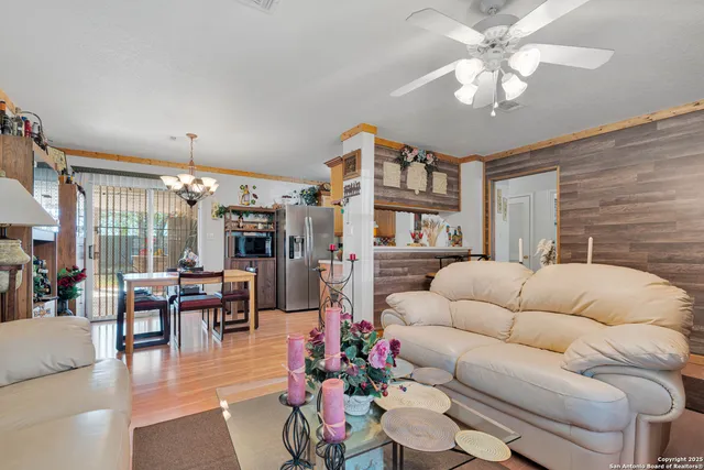 a living room with furniture dining area and a chandelier