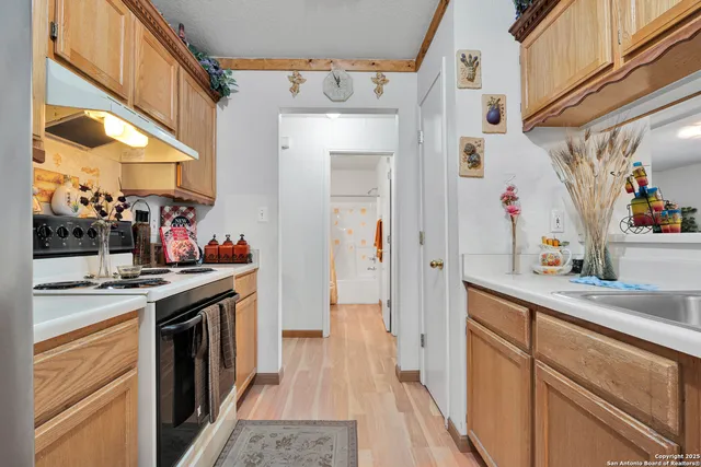 a kitchen with stainless steel appliances granite countertop a sink and cabinets