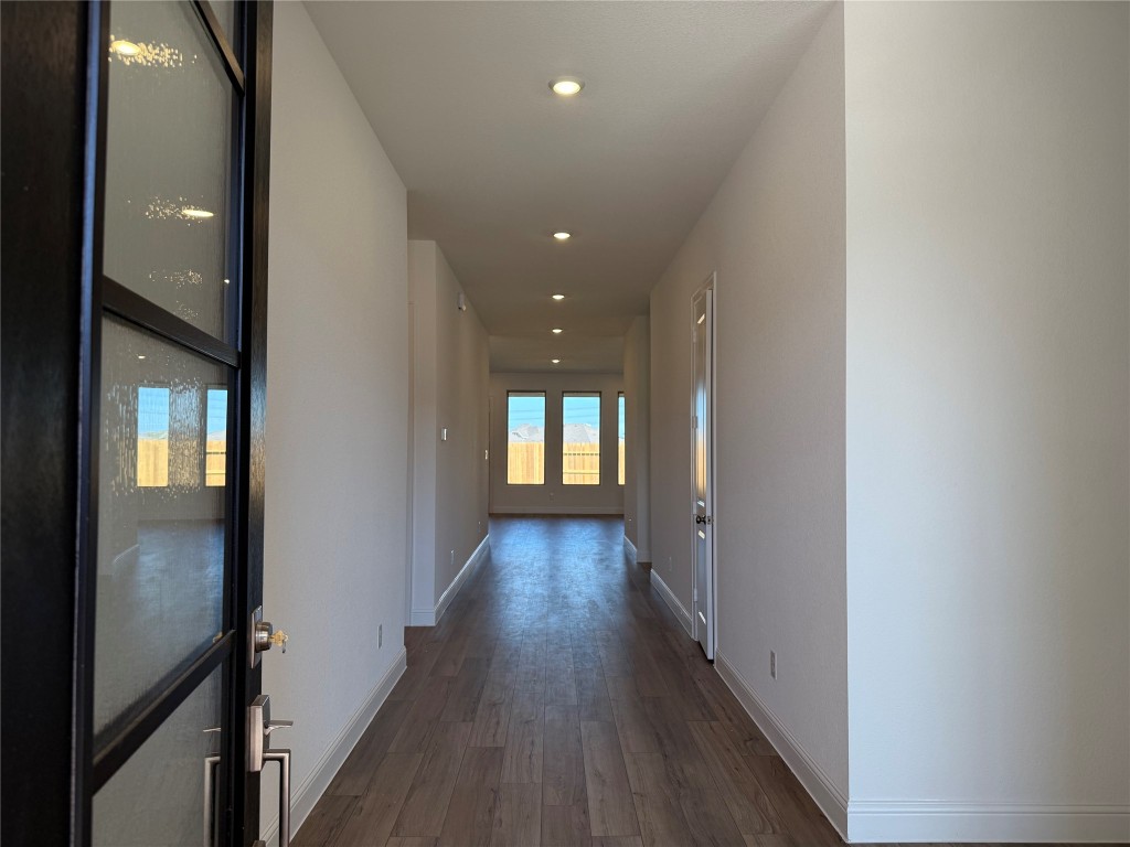 31527 Fern Grove Road Fulshear, TX 77423 - Photo 2 of 21 a view of a hallway with wooden floor and stairs