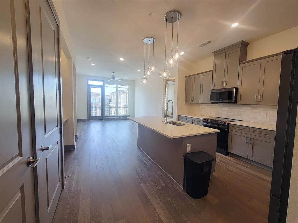 2700 Old Denton Road, Unit 4407 Carrollton, TX 75007 - Photo 16 of 34 a kitchen with a sink stainless steel appliances and cabinets